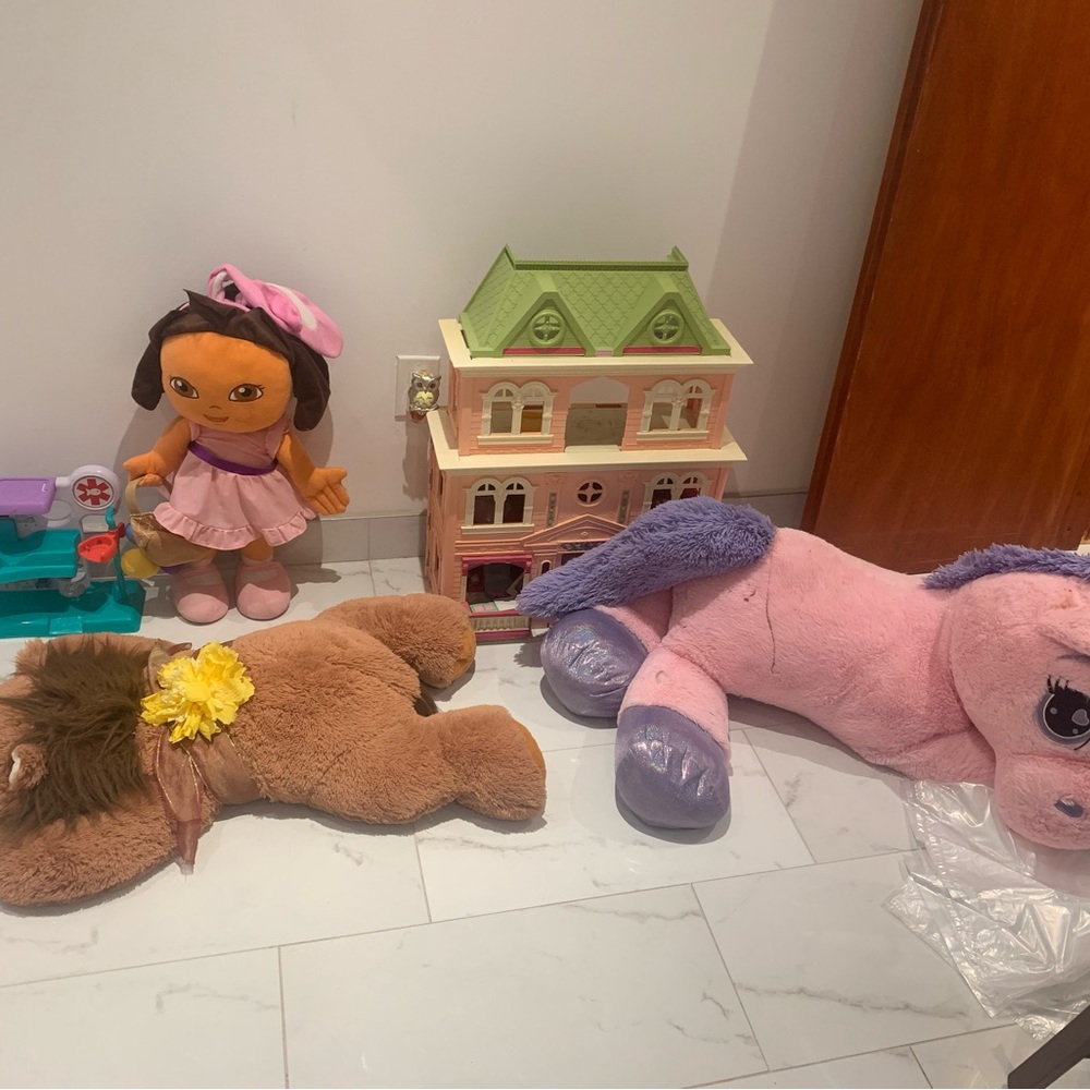 3 stuffed animals one doll house and another toy, they all are used
